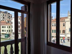 a window with a view of a city street at Guglie Palace in Venice