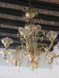 a gold chandelier hanging from a ceiling at Guglie Palace in Venice