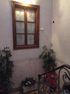 a window in a building with a bench in front of it at Casa Tradicional Algarvia - Rooms in Faro