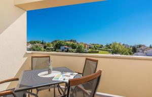 a table and chairs on a balcony with a view at Apartments Hana in Funtana in Funtana