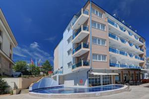 a hotel with a swimming pool in front of it at Paraiso Beach - All Inclusive in Obzor
