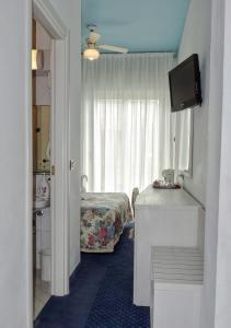Postel nebo postele na pokoji v ubytování Hotel Tridentum