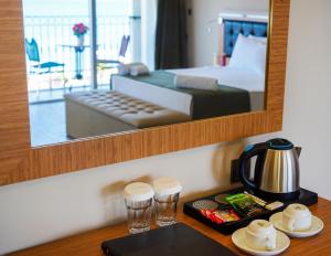Postel nebo postele na pokoji v ubytování Aurasia Sea Side Hotel