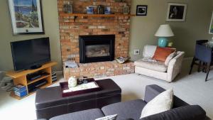 a living room with a couch and a fireplace at Window Hill in St. Albert