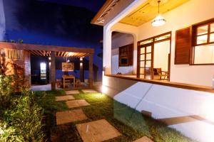 a patio of a house at night at Green 53 Boutique Hotel in Ilhéus