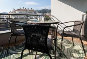 a balcony with a table and chairs on a roof at Lets Holidays Apartment Commercial Area in Tossa de Mar