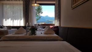a table in a restaurant with a view of a mountain at Pension Volgger in Rodengo