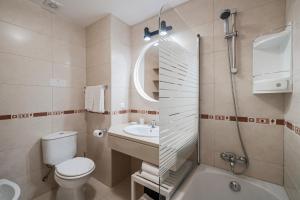 a bathroom with a toilet and a sink and a shower at Garajau III by An Island Apart in Caniço +15 photos