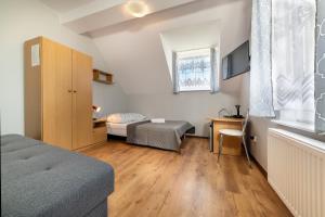 a bedroom with a bed and a desk and a table at D.W. KRYSTYNA in Dębki +17 photos