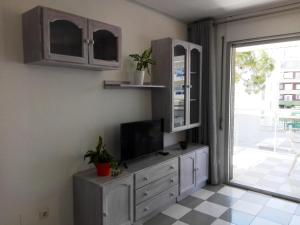 a living room with a tv on a dresser at Zeus Montblanc in Salou