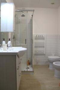 a bathroom with a sink and a toilet and a shower at Along the Canal smart flat Naviglio - 4 people in Corsico