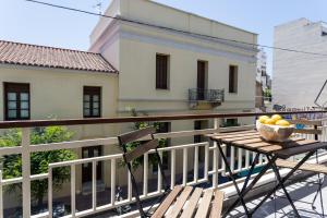雅典的住宿－Urban Athens Apartment，坐在阳台上桌子上的一碗水果