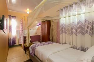 a bedroom with two beds and a canopy at Zarita Boutique Hotel in Nairobi +132 photos