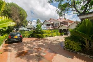 a car parked in the driveway of a house at Zarita Boutique Hotel in Nairobi