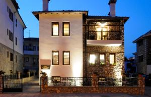 
a large white building with a large window at Guesthouse Konstantinos Bakaris in Kastoria
