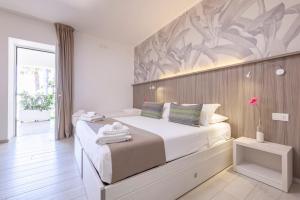 a bedroom with a large bed with a wall mural at Relais Regina Rosanna in Gallipoli +60 photos