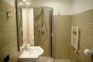 a bathroom with a sink and a shower at Business Home Piazza Cesare Battisti B&B Residence in Foggia