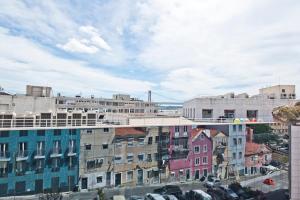 a view of a city with buildings and a bridge at BmyGuest Bruno’s 36 Apartments in Lisbon