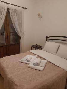 a bed with two white towels on top of it at Doga Apartment in Famagusta