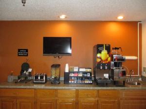 a kitchen with a counter with a tv on the wall at Heritage Inn Express in Marysville