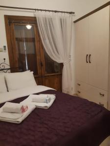 a bedroom with a bed with towels on it at Doga Apartment in Famagusta