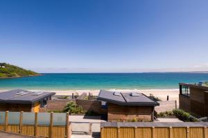 a view of a beach with houses and the ocean at Carbis Bay and Spa Hotel in St Ives