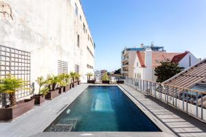 a swimming pool on the side of a building at Chalet Estoril Luxury Apartments in Estoril