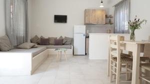 a living room with a couch and a kitchen at Armonia Houses in Tsonia