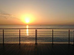 a sunset over the ocean from a pier at Villa Azur in Villeneuve-Loubet