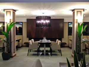 a dining room with a table and chairs and a chandelier at Villa Azur in Villeneuve-Loubet
