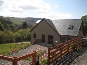 a house with a garden in front of it at Rockfoot B&B in Fintry