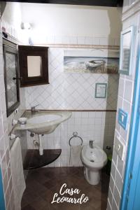 a bathroom with a sink and a toilet at Casa Leonardo in Favignana +22 photos