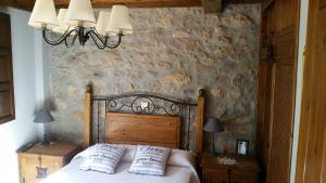 a bedroom with a bed with two pillows on it at LAS VILLAS DEL PONTON in Trescares