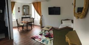 a living room with a bed and a table and chairs at Casa romantica in Chaussy