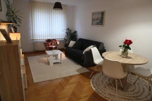 ein Wohnzimmer mit einem Sofa und einem Tisch in der Unterkunft Vana apartment Zagreb in Zagreb
