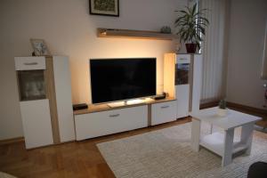 ein Wohnzimmer mit einem TV in einem weißen Unterhaltungszentrum in der Unterkunft Vana apartment Zagreb in Zagreb
