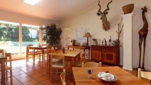 a living room with a table and a dining room at Somer Place B&B in Somerset West