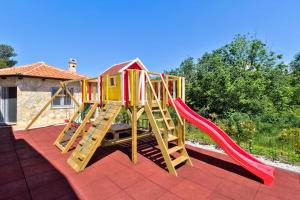 a play set with a slide and a slideintend at Istrian Guest House ILLY in Kaštel