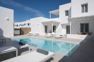 a swimming pool in the middle of a house at White Blossom in Parikia