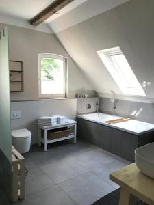 a bathroom with a tub and a toilet and a sink at Villa Hanne mit Garten in Thale +39 photos