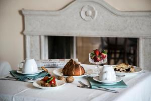 a table topped with plates of food and desserts at La Dolce Vista - B&B di Charme in Manfredonia