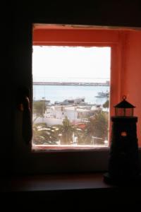 a window with a view of the ocean and a lighthouse at La Dolce Vista - B&B di Charme in Manfredonia