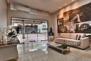 a living room with a couch and a table at Zallon Hotel Executivo in Lajeado