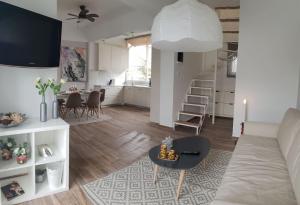 a living room with a couch and a table at Seaside Maisonette House in Artemida