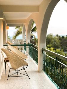 two chairs on a balcony with a view of the ocean at Hotel Suites Villasol in Puerto Escondido