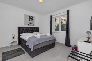 a bedroom with a large bed and a window at Apartments Morpheus in Makarska