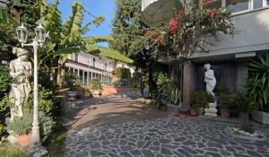 a courtyard with statues and plants in a building at La Chandelle in Massarosa