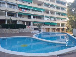 a large swimming pool in front of a building at Luxury CAP SALOU with POOL & BARBECUE & WIFI in Salou