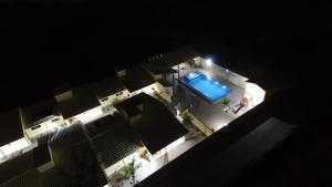an overhead view of a swimming pool at night at Chalés Estrelas Do Mar in Barra Nova