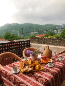 a table with a plate of food on it at Syunyats guest house in Halidzor